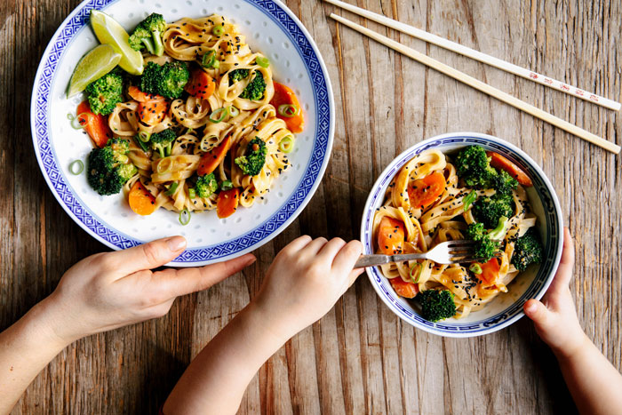 asiatischer wok mit brokkoli und reisbandnudeln